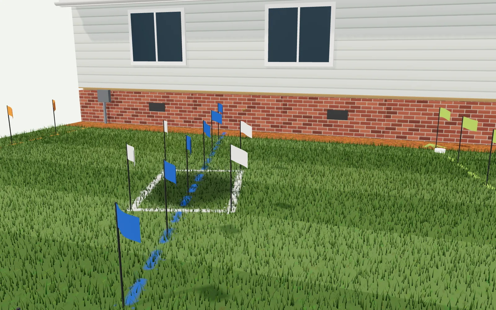 Low over a front lawn: marking flags in blue, green, yellow, orange and red over painted lines, a white-lined dig box and a dark wet patch in the grass